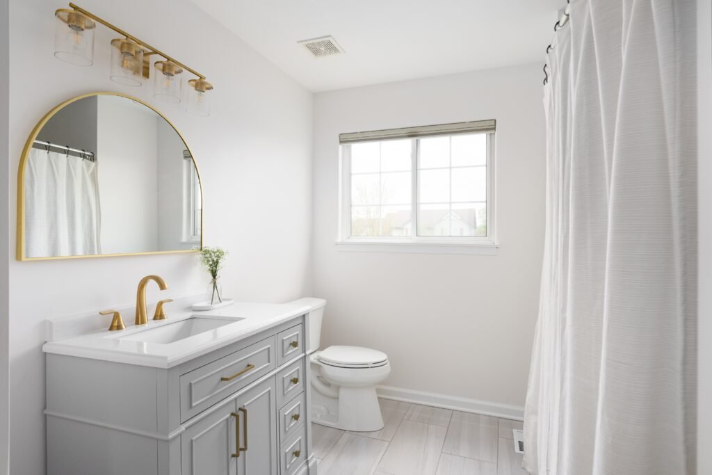 a,bathroom,with,a,grey,cabinet,,white,countertop,,tile,flooring,